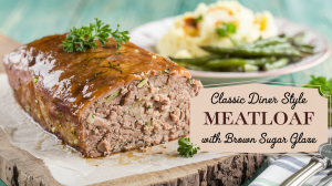 A warm and inviting photo of a golden-brown meatloaf with a caramelized brown sugar glaze on a rustic wooden cutting board. The meatloaf has a moist and tender interior flecked with onions and herbs. Fresh parsley is scattered over the top for a pop of color. A plate of buttery mashed potatoes and roasted green beans is placed beside the meatloaf. The overall scene exudes the warmth of a classic family dinner. The text "Classic Diner Style Meatloaf with Brown Sugar Glaze" is overlayed in a soft, feminine country font.