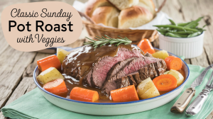 A photo of a steaming platter of beef pot roast on a rustic wooden table. The roast is surrounded by vibrant orange carrots, golden potatoes, and thick slices of beef swimming in a glossy brown gravy. Fresh rosemary sprigs garnish the dish, adding a touch of green. In the background, a basket of freshly baked rolls and a bowl of crisp green beans complete the scene. The title text "Classic Sunday Pot Roast with Veggies" is overlaid in a soft feminine country font.