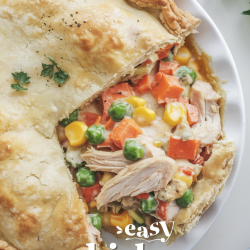 A comforting chicken pot pie is sliced open to reveal a colorful and hearty filling of tender shredded chicken, vibrant peas, corn, and carrots, all nestled in a creamy, savory sauce. The golden-brown, flaky crust glistens with a buttery finish, with small garnishes of fresh parsley scattered on top for a pop of green. The dish is served on a white plate, highlighting the warmth and homemade charm of this classic comfort food. Overlay the image with warm, casual text, featuring the short title: "Easy Chicken Pot Pie" . Ensure the text is clear and not overly busy. The footer should contain the URL: "MAMABEARRECIPES.COM in a banner".