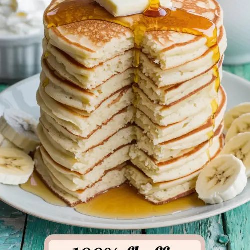 A photo of a tall stack of golden buttermilk pancakes with a fluffy texture. There is a generous pat of butter melting on top, and a drizzle of warm maple syrup glistens. Next to the stack, there is a small bowl of fresh banana slices and a dish of whipped cream. The pancakes' edges are slightly crispy, providing a perfect contrast to their pillowy centers. There is a steaming cup of coffee nearby. The background is a rustic wooden surface. The title text "100% Fluffy Homemade Buttermilk Pancakes" is overlaid in a soft feminine country font.