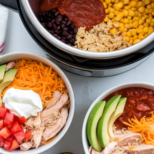 Instant Pot chicken taco bowls with rice, beans, and toppings.